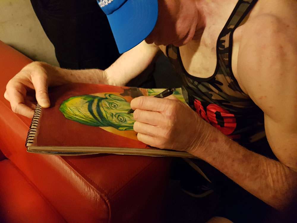 Yellowman signing Yelloman portrait drawing. Polychromos colored pencils on Strathmore Toned Tan 118 gr (27,9x35,6) @ Q-Factory (2019) (svenimal.art)